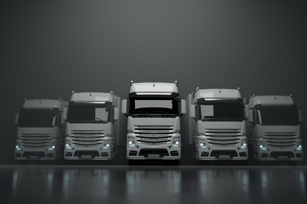 Commercial trucks parked in a secure row representing fleet safety and transport security.